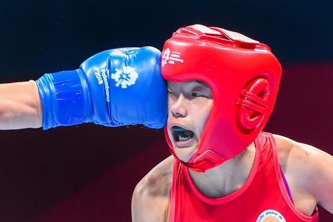 India's Samjetsabam Sarjubala and Chinas Chang Yuan during the women's fly (51 kg) quarter-final boxing event, in 18th Asian Games 2018, in Jakarta on Wednesday