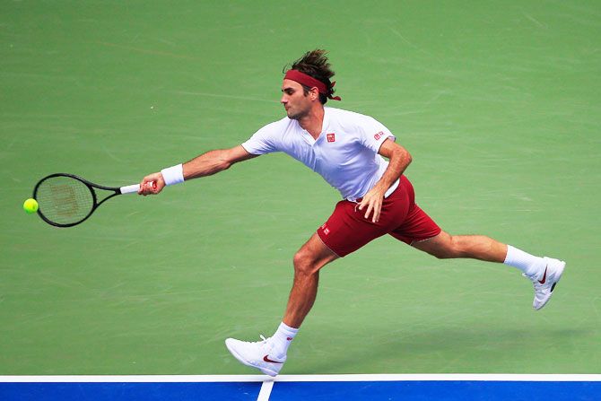 Switzerland's Roger Federer returns the ball against France's Benoit Paire during his US Open men's singles second round match at the USTA Billie Jean King National Tennis Center in the Flushing neighborhood of the Queens borough of New York City on Thursday