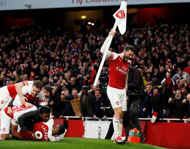Arsenal's Alexandre Lacazette celebrates scoring their third goal with teammates as Sead Kolasinac grabs the corner flag during the match against Tottenham Hotspur 