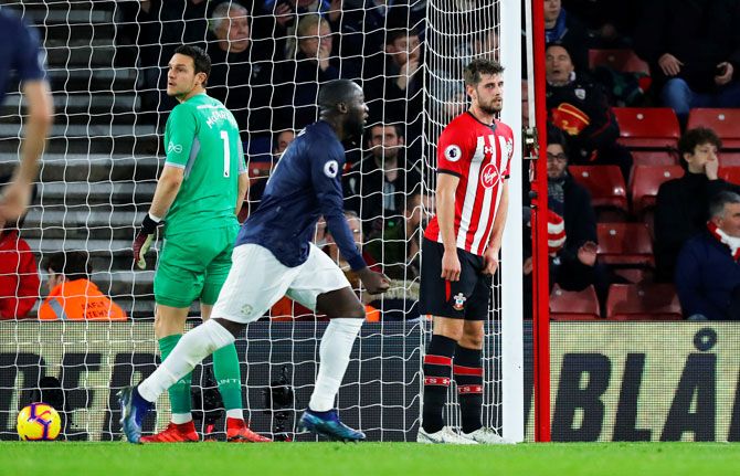 Manchester United's Romelu Lukaku celebrates their second goal as Southampton's Jack Stephens and Alex McCarthy look dejected during their match at St Mary's Stadium in Southampton 