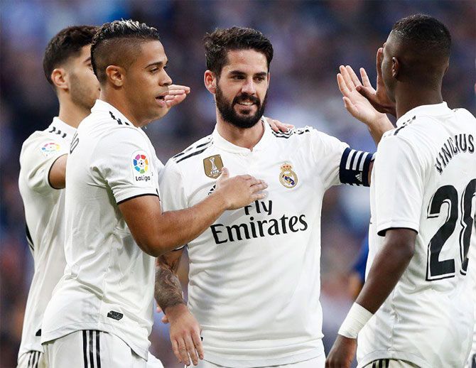 Real Madrid's Isco Alarcon celebrates with teammates after scoring against Melilla on Thursday. It was the first time he scored since September