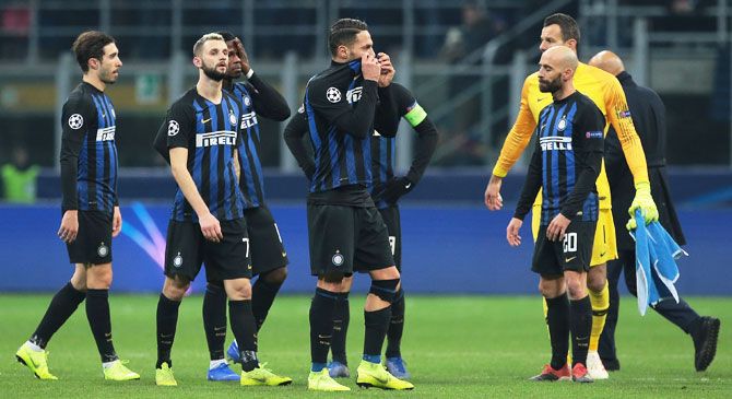 Inter Milan players wear a dejected look after their loss to PSV at San Siro in Milan