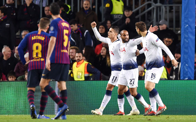 Tottenham Hotspur's Lucas Moura celebrates with Erik Lamela and Fernando Llorente after scoring during their UEFA Champions League Group B match against FC Barcelona at Camp Nou in Barcelona, Spain, on Tuesday