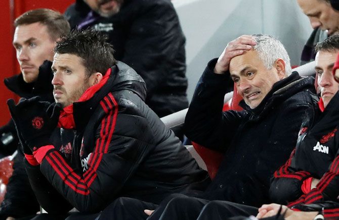 Manchester United manager Jose Mourinho reacts as assistant coach Michael Carrick looks on
