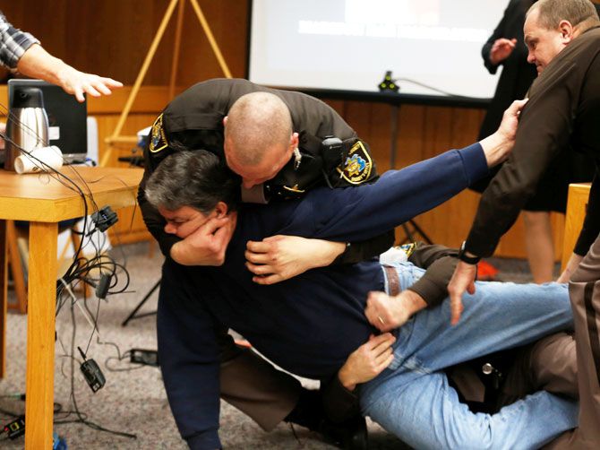 Eaton County Sheriffs restrain Randall Margraves after he lunged at Larry Nassar, a former team USA Gymnastics doctor, who pleaded guilty in November 2017 to sexual assault charges, during victim statements of his sentencing in the Eaton County Circuit Court in Charlotte, Michigan, USA on Friday