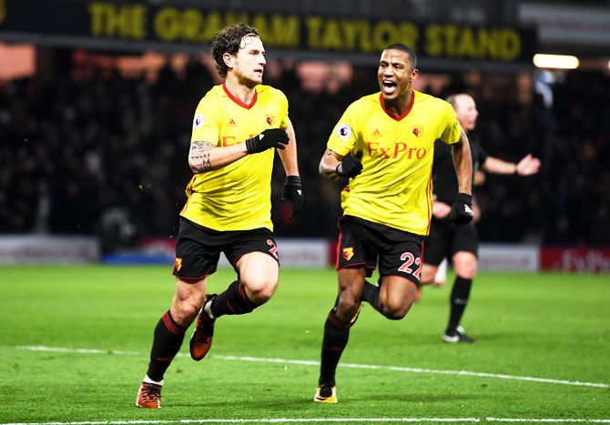Watford's Daryl Janmaat celebrates with teammate Marvin Zeegelaar scoring the 2nd goal of Watford during the Premier League match between Watford and Chelsea at Vicarage Road in Watford on Tuesday
