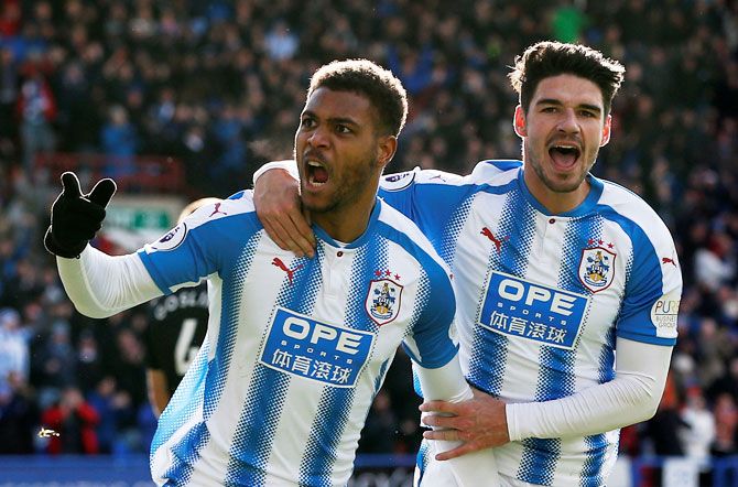 Huddersfield Town’s Steve Mounie celebrates scoring their second goal with Christopher Schindler during their match against AFC Bournemouth at John Smith’s Stadium in Huddersfield