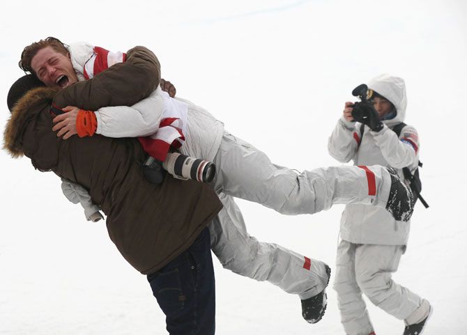 US snowboarding gold medallist Shaun White hugs a friend after the scores of the men's halfpipe finals are announced at the Phoenix Snow Park in Pyeongchang, South Korea, on Wednesday