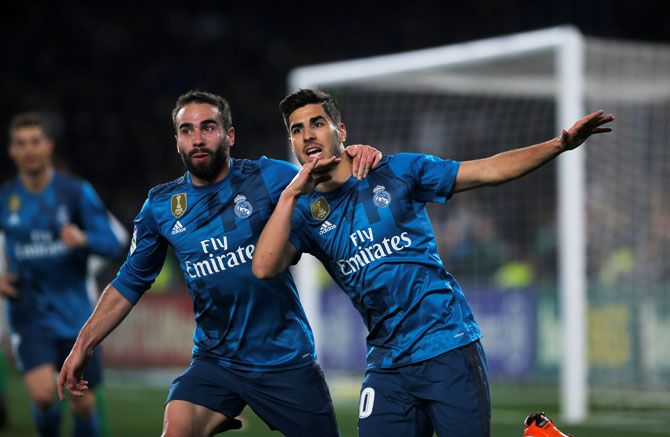 Real Madrid’s Marco Asensio celebrates with teammate with Dani Carvajal after scoring their third goal against Real Betis in their La Liga at Estadio Benito Villamarin, Seville on Sunday