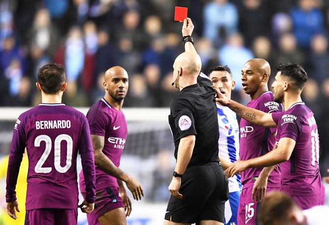 Fabian Delph of Manchester City is shown a red card by referee Anthony Taylor