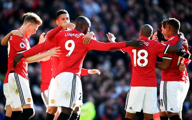 Manchester United's Romelu Lukaku celebrates with teammates after scoring his side's first goal against Chelsea during their English Premier League match at Old Trafford in Manchester on Sunday