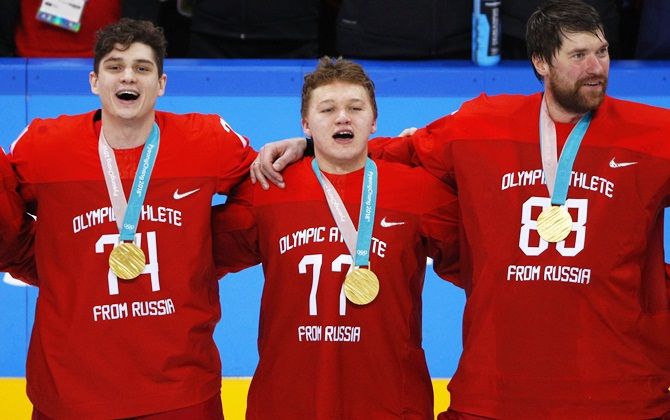 Members of Russia's Ice Hockey Olympic team Nikolai Prokhorkin (left) and teammates Kirill Kaprizov and goalie Vasili Koshechkin sing the national anthem after winning the gold medal at the Gangneung Hockey Centre in Gangneung, South Korea  on Sunday