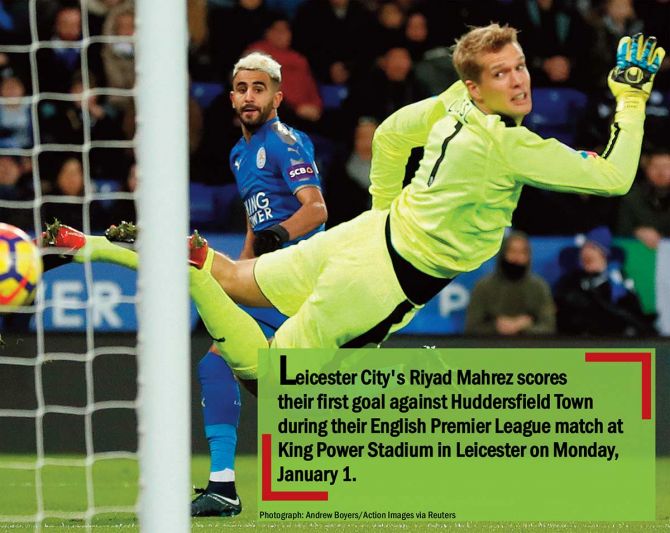 Leicester City's Riyad Mahrez scores their first goal against Huddersfield Town during their English Premier League match at King Power Stadium in Leicester on Monday, January 1