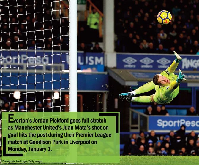 Everton’s Jordan Pickford goes full stretch as Manchester United’s Juan Mata’s shot on goal hits the post during their Premier League match at Goodison Park in Liverpool on Monday, January 1
