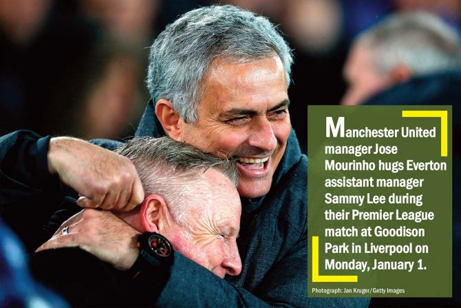 Manchester United manager Jose Mourinho hugs Everton assistant manager Sammy Lee during their Premier League match at Goodison Park in Liverpool on Monday, January 1