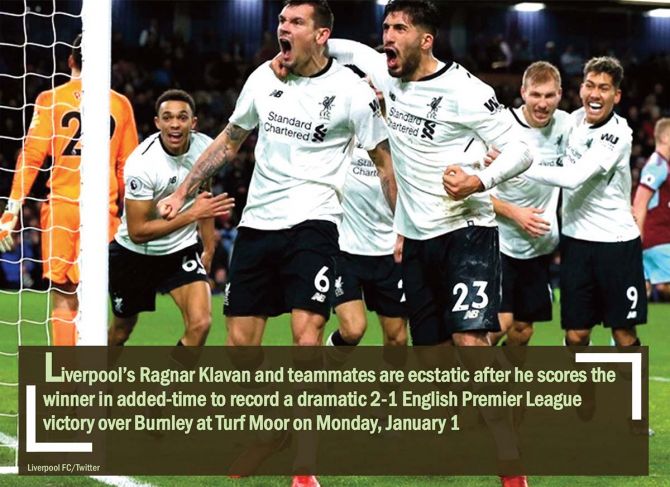 Liverpool’s Ragnar Klavan and teammates are ecstatic after he scores the winner in added-time to record a dramatic 2-1 English Premier League victory over Burnley at Turf Moor on Monday, January 1