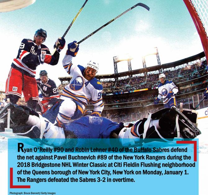 Ryan O'Reilly #90 and Robin Lehner #40 of the Buffalo Sabres defend the net against Pavel Buchnevich #89 of the New York Rangers during the 2018 Bridgestone NHL Winter Classic at Citi Fieldin Flushing neighborhood of the Queens borough of New York City, New York on Monday January 1. The Rangers defeated the Sabres 3-2 in overtime.
