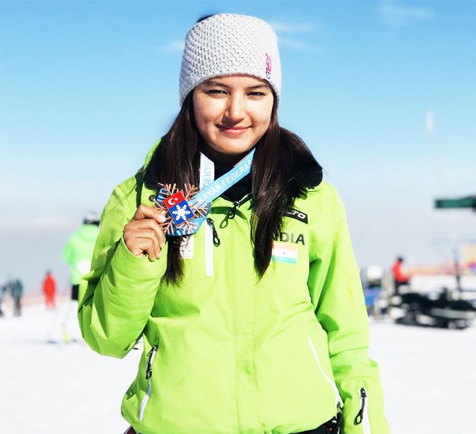 Indian skier Aanchel Thakur shows off her medal