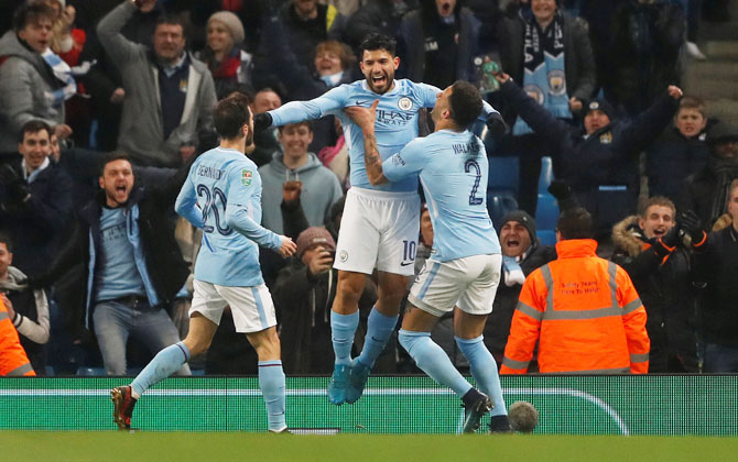 Manchester City's Sergio Aguero celebrates with teammates on heading in the winner of the League Cup semi-final first leg against Bristol City at Etihad Stadium on Tuesday