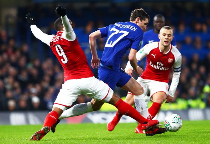Chelsea's Andreas Christensen holds off a challenge by Arsenal's Alexandre Lacazette