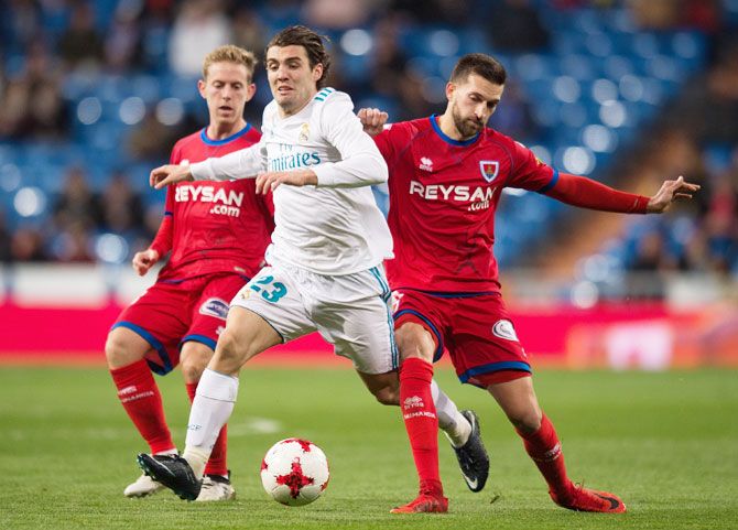 Real Madrid's Mateo Kovacic is tackled by Numancia's Gregorio Sierra (right) during the Copa del Rey, round of 16, second leg match at estadio Santiago Bernabeu in Madrid, on Wednesday