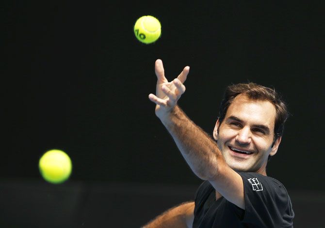 Switzerland's Roger Federer shares a light moment during a practice session before the Australian Open tennis tournament on Sunday
