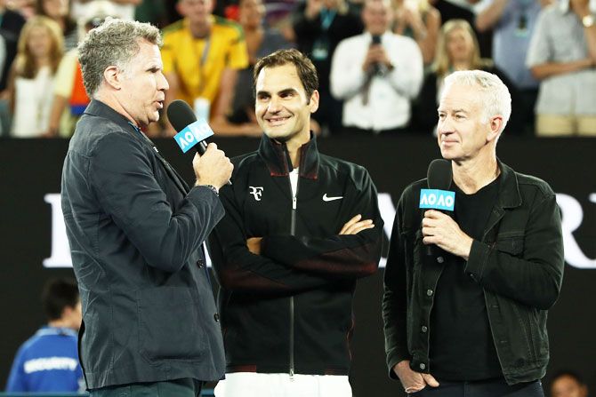 Hollywood actor and comedian Will Ferrell (left) and John McEnroe (right) interview Roger Federer after winning his first round match against Aljaz Bedene on Day 2 of the 2018 Australian Open at Melbourne Park in Melbourne on Tuesday