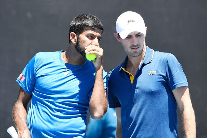 India's Rohan Bopanna (left) and France's Edouard Roger-Vasselin talk tactics in their first round men's doubles match against USA's Ryan Harrison and Canada's Vasek Pospisil on day four of the 2018 Australian Open at Melbourne Park on Thursday