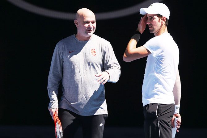 Andre Agassi and Novak Djokovic at a training session