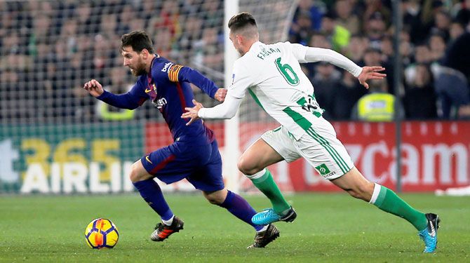 Barcelona’s Lionel Messi runs past Real Betis' Fabian