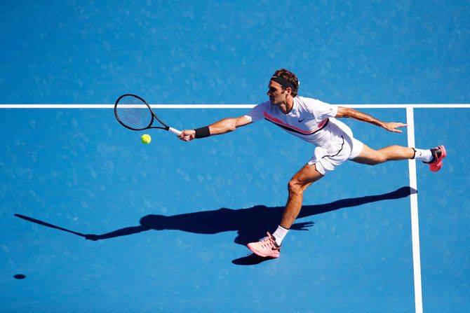 Switzerland's Roger Federer plays a forehand in his fourth round match against Hungary's Marton Fucsovics at Melbourne Park on Monday