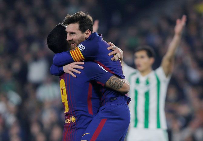 Barcelona’s Luis Suarez and Lionel Messi celebrate a goal against Real Betis at the Estadio Benito Villamarin in Seville on Sunday
