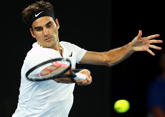 Roger Federer plays a forehand return