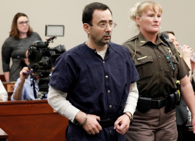 Larry Nassar, a former team USA Gymnastics doctor, who pleaded guilty in November 2017 to sexual assault charges, is led from the courtroom after listening to victim testimony during his sentencing hearing in Lansing, Michigan on Jan 25 2018