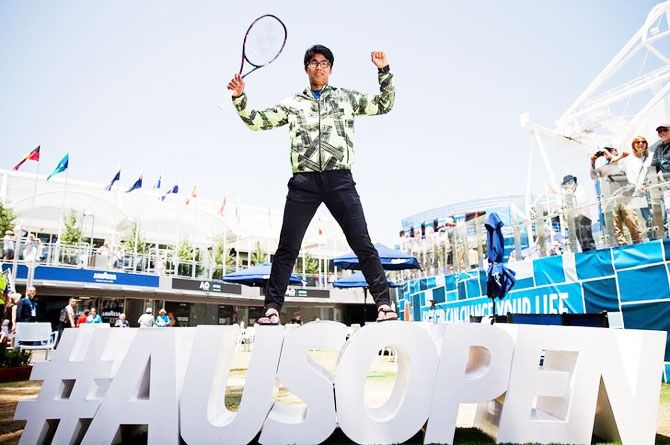 South Korea's Chung Hyeon poses on the Australian Open hashtag sign during an official event promoting the tournament in Garden Square, Melbourne Park, Melbourne on Thursday