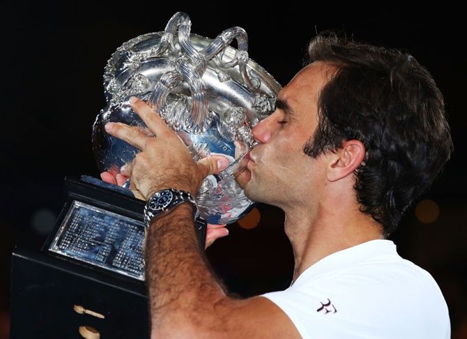 Roger Federer kisses the Norman Brookes Challenge Cup after winning the 2018 Australian Open, his 20th Grand Slam title