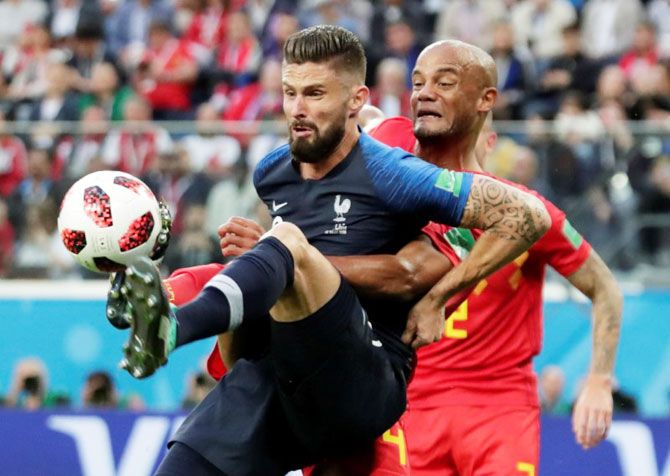 France's Olivier Giroud holds off with Belgium's Vincent Kompany as they battle for the ball