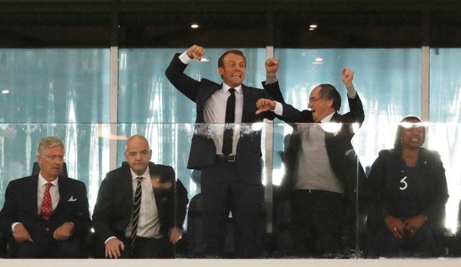 French President Emmanuel Macron (centre) celebrates as King Philippe of Belgium (left) looks on alongside FIFA president Gianni Infantino at the end of the FIFA World Cup semi-final match between France and Belgium on Tuesday