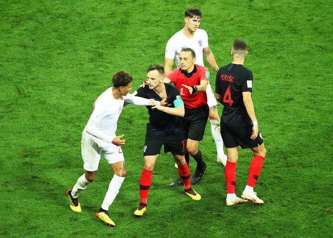 Croatia's Ivan Rakitic (right) is restrained by the referee as he gets into a scuffle with England's Dele Alli