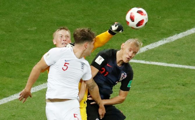 England's keeper Jordan Pickford punches the ball as he makes an aerial clearance