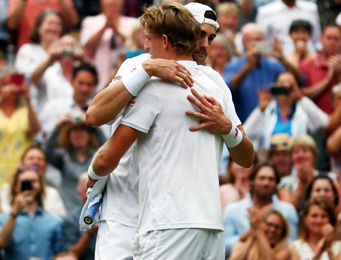 South Africa’s Kevin Anderson hugs USA's John Isner after their Wimbledon men's singles semi-final. The match lasted six hours and 36 minutes