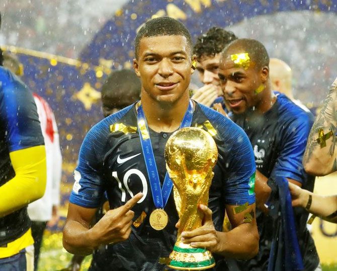 France's Kylian Mbappe celebrates with the trophy