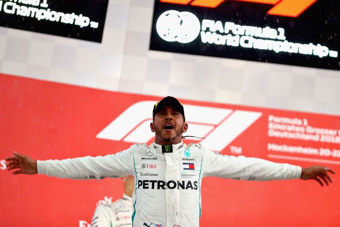 Race winner Mercedes GP's British driver Lewis Hamilton celebrates on the podium on winning the Formula One Grand Prix of Germany at Hockenheimring in Hockenheim, Germany, on Sunday