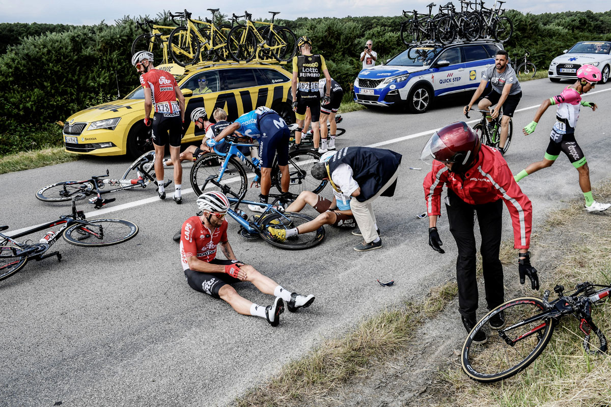 France's Axel Domont, Poland's Tomasz Marczynski, Belgium's Jelle Vanendert and Colombia's Daniel Martinez react after being caught in a massive pack fall in the last kilometers of the 195-km Stage 4 from La Baule to Sarzeau on July 10