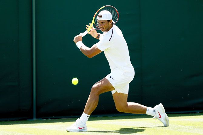 Rafael Nadal practices on court during training for the Wimbledon Lawn Tennis Championships at the All England Lawn Tennis and Croquet Club at Wimbledon on Saturday