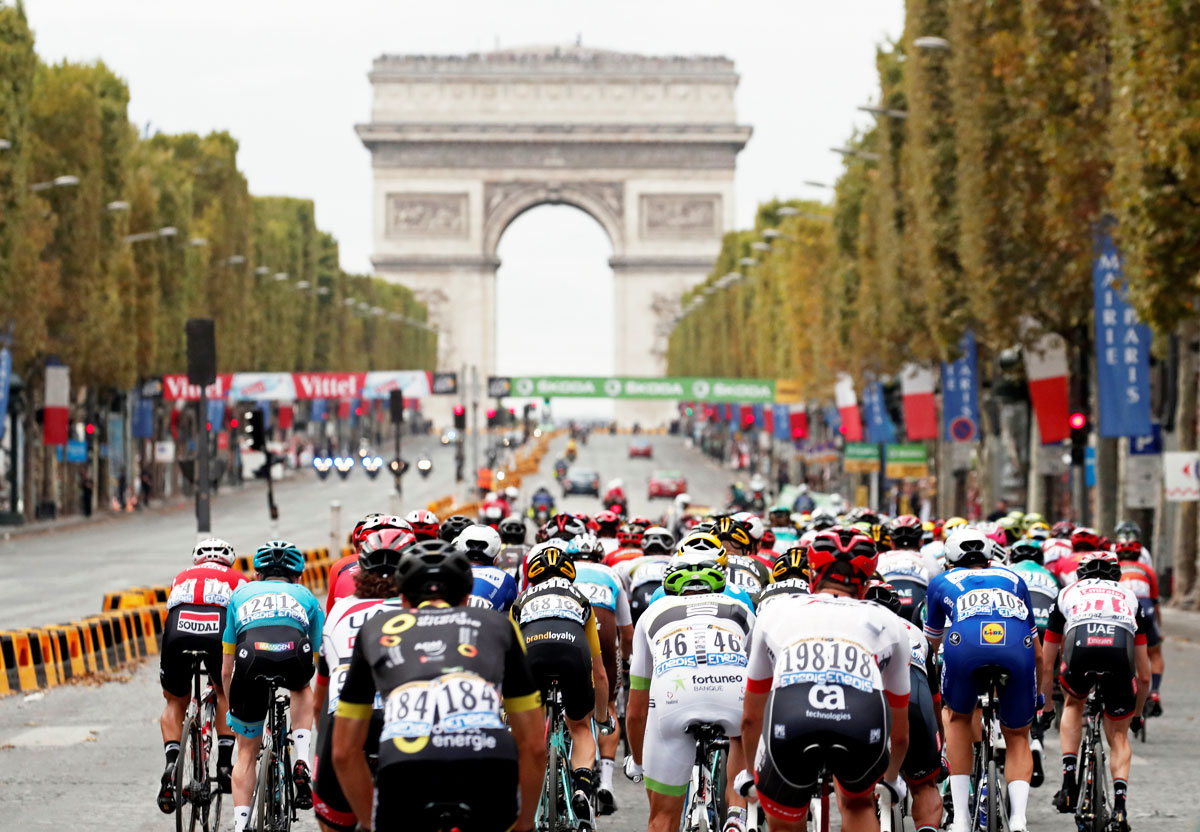 The peloton races towards the Arc de Triomphe on the final stretch of the 116-km Stage 21 from Houilles to Paris Champs-Elysees at Tour de France on Sunday