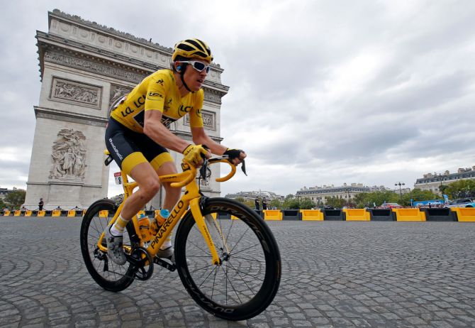 Team Sky rider Geraint Thomas of Britain, wearing the overall leader's yellow jersey, passes the Arc de Triomphe at the 116-km Stage 21 from Houilles to Paris Champs-Elysees on Sunday