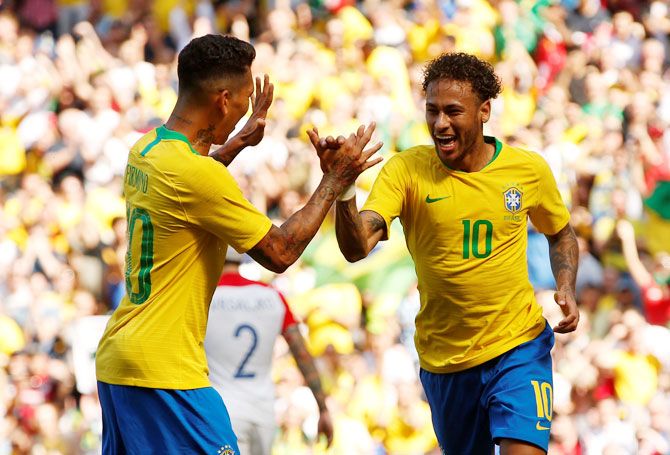Brazil's Neymar celebrates with Roberto Firmino after scoring their first goal against Croatia during an international friendly at Anfield in Liverpool on Sunday