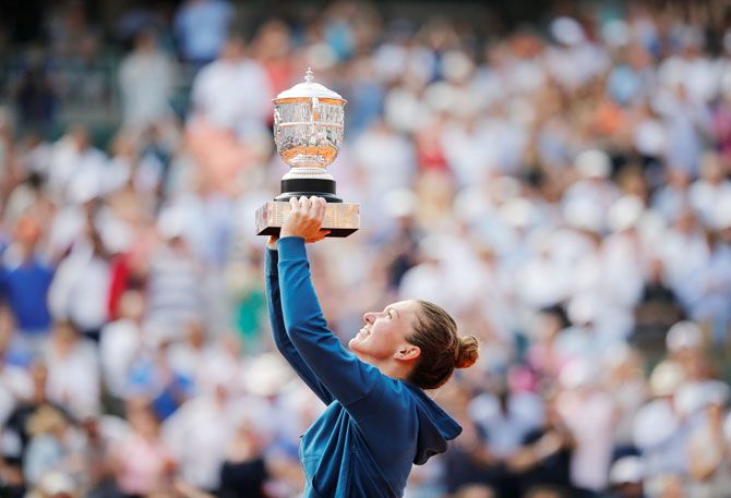Romania’s Simona Halep celebrates with the trophy after winning the French Open final on Saturday