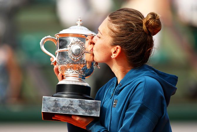 Romania's Simona Halep kisses the trophy after beating USA's Sloane Stephens to win the 2018 French Open final at Roland Garros in Paris on Saturday